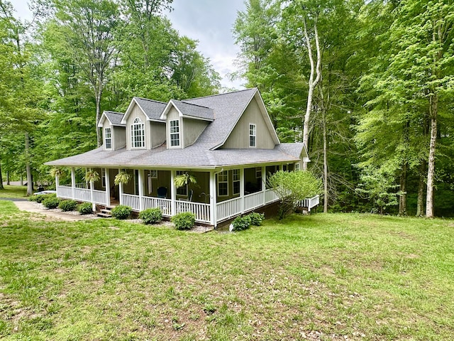 view of front of home featuring a porch, a front lawn, and roof with shingles