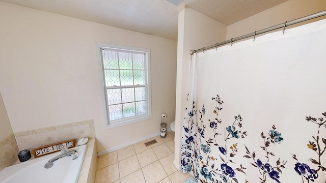 full bath with tile patterned floors, toilet, visible vents, baseboards, and a garden tub