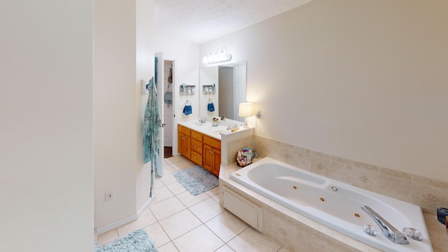 full bathroom with tile patterned floors, a whirlpool tub, and vanity
