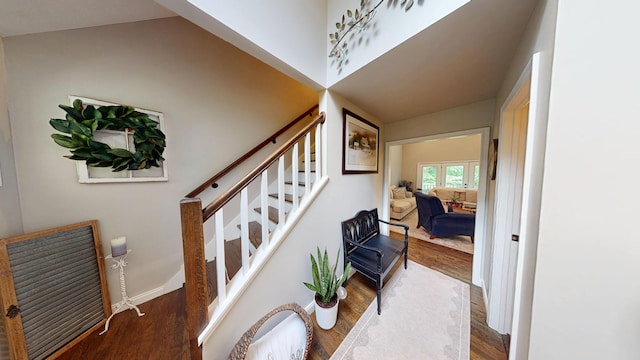 stairway with wood finished floors and baseboards