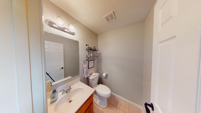 half bath featuring tile patterned floors, toilet, vanity, visible vents, and a textured ceiling