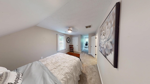 bedroom featuring light carpet, ceiling fan, baseboards, visible vents, and lofted ceiling
