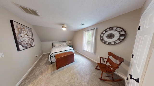 carpeted bedroom with a textured ceiling, visible vents, and baseboards