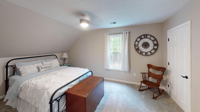 carpeted bedroom with visible vents, ceiling fan, vaulted ceiling, and baseboards