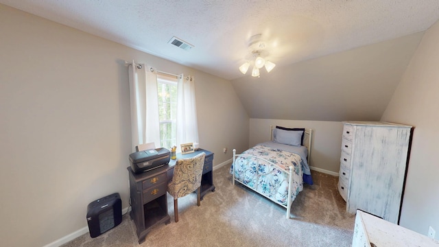 carpeted bedroom with lofted ceiling, a textured ceiling, visible vents, and baseboards
