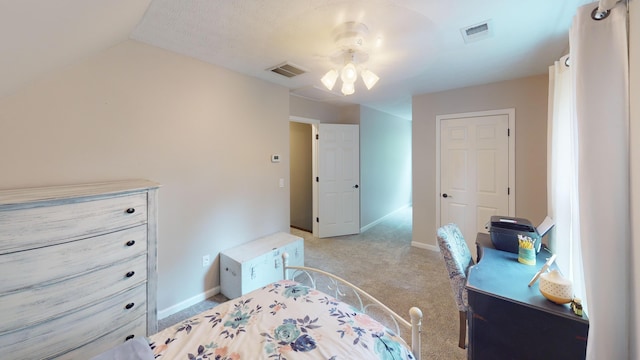 bedroom with baseboards, visible vents, lofted ceiling, and light colored carpet
