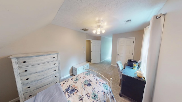 bedroom with lofted ceiling, light colored carpet, visible vents, and baseboards