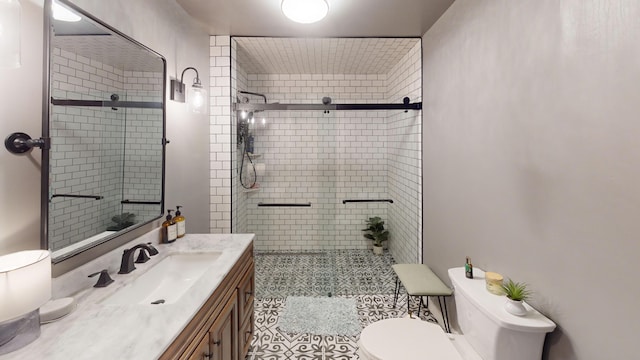 full bath featuring tile patterned floors, vanity, toilet, and a stall shower