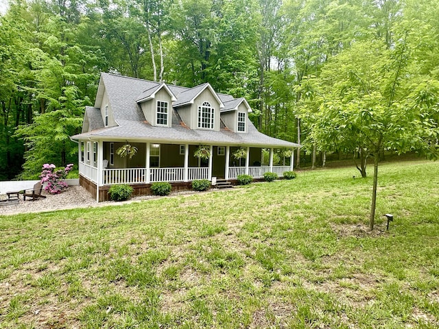 farmhouse with a front yard, a shingled roof, and covered porch