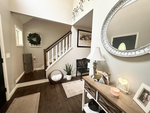 entrance foyer with stairs, wood finished floors, and baseboards