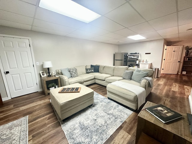 living area with wood finished floors and a drop ceiling