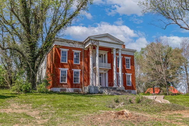 neoclassical home with a front yard