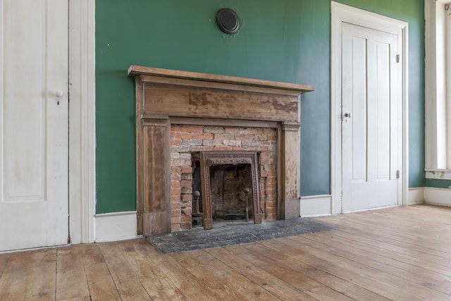 interior details featuring wood finished floors and a fireplace