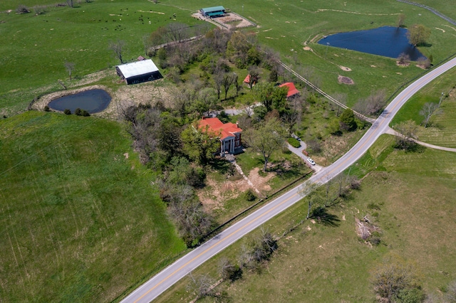 drone / aerial view featuring a water view and a rural view