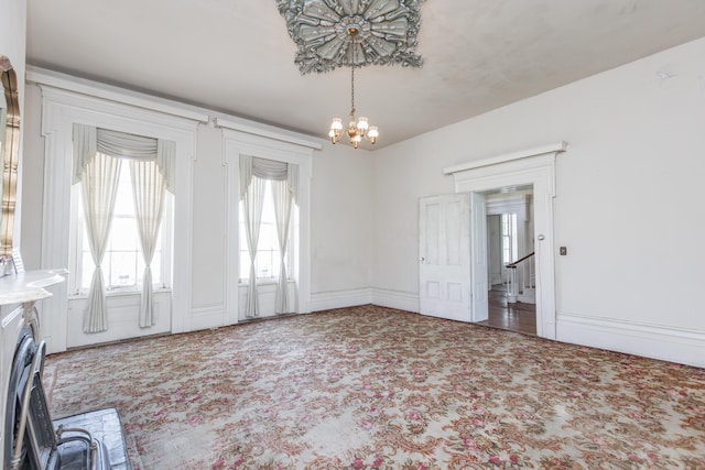 interior space with carpet floors and a chandelier