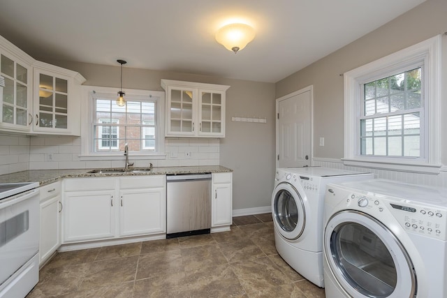 laundry room with separate washer and dryer, a sink, laundry area, and plenty of natural light
