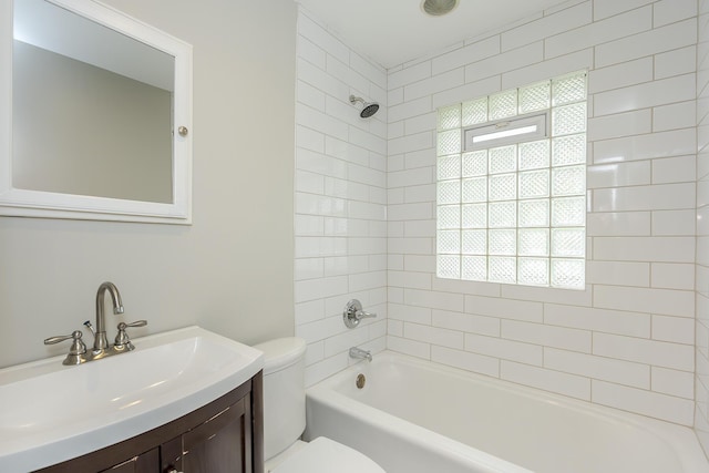 bathroom with toilet,  shower combination, and vanity