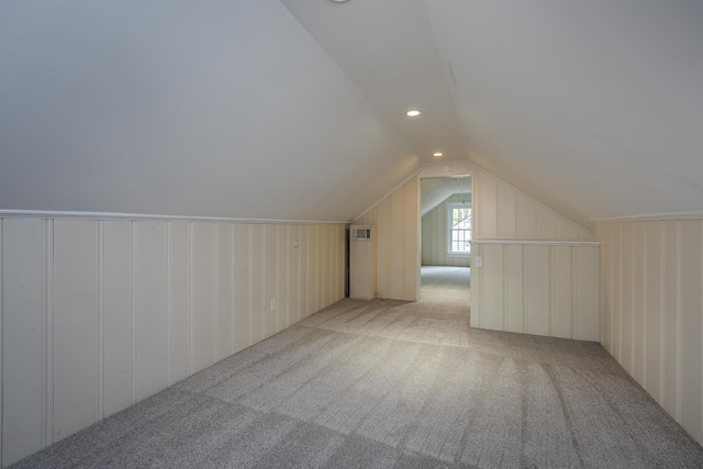 bonus room featuring lofted ceiling and light colored carpet