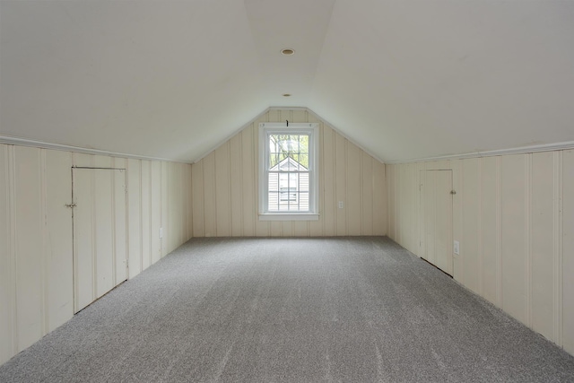 bonus room with carpet and vaulted ceiling