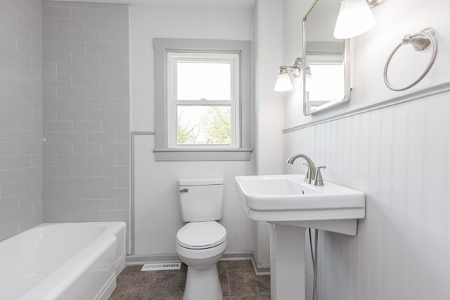 bathroom featuring tile patterned floors, visible vents, toilet, and shower / washtub combination
