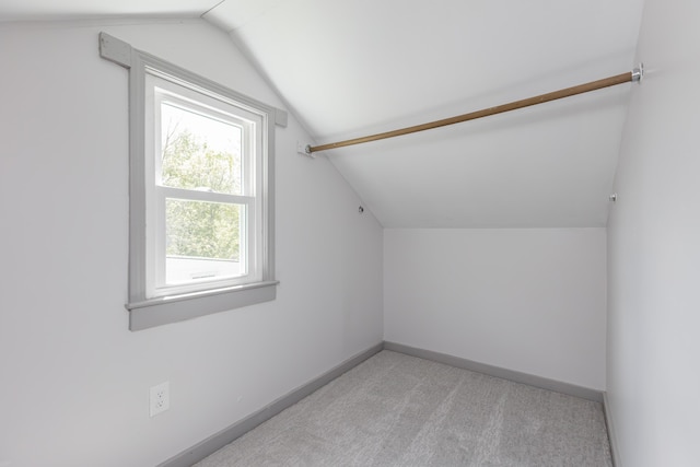 bonus room featuring carpet, vaulted ceiling, and baseboards