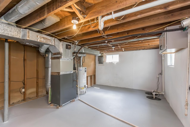 basement featuring heating unit, gas water heater, and electric panel