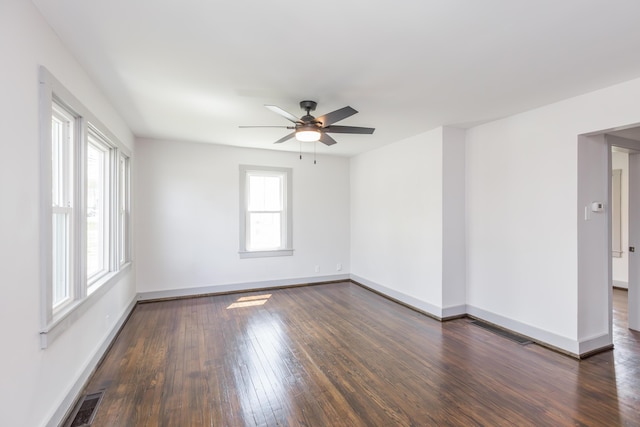 unfurnished room with dark wood-style floors, baseboards, and a ceiling fan