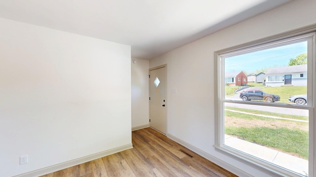 entrance foyer featuring visible vents, light wood-style flooring, and baseboards
