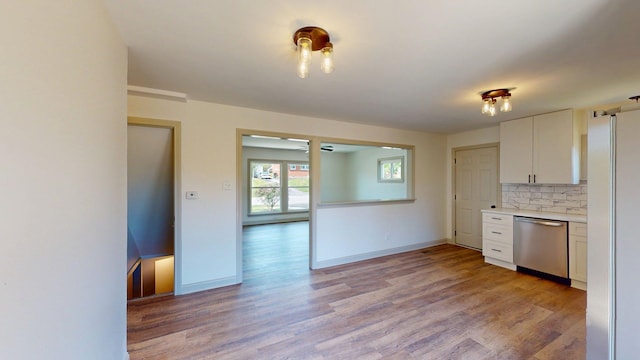 kitchen with light countertops, white cabinets, light wood-type flooring, and dishwasher
