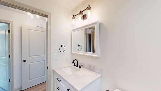 bathroom featuring wood finished floors and vanity