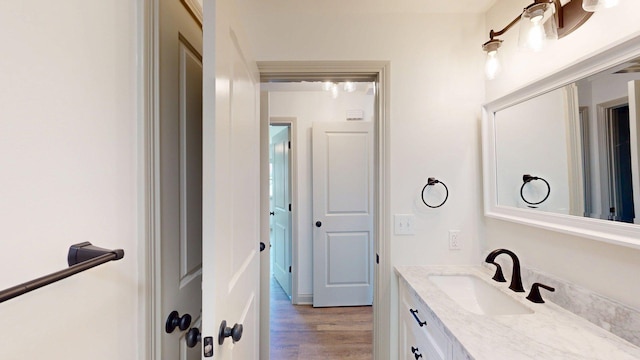 bathroom with wood finished floors and vanity