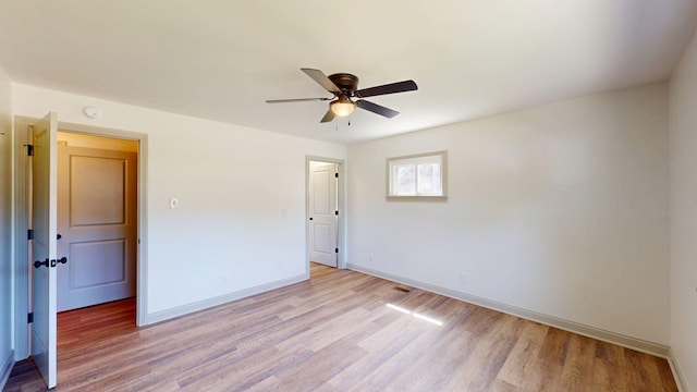 unfurnished room with a ceiling fan, baseboards, and light wood finished floors