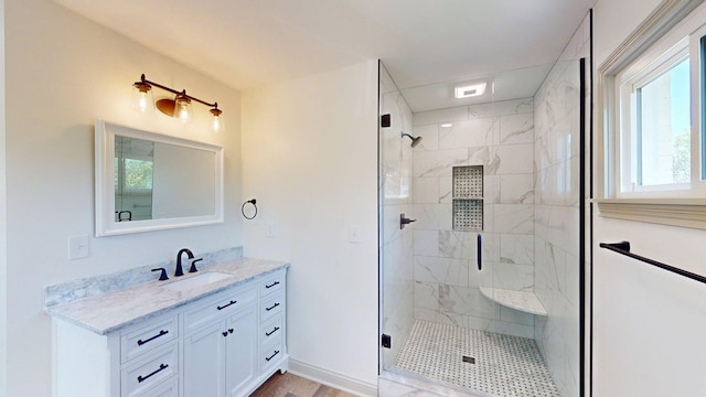 bathroom with vanity, a stall shower, and a healthy amount of sunlight