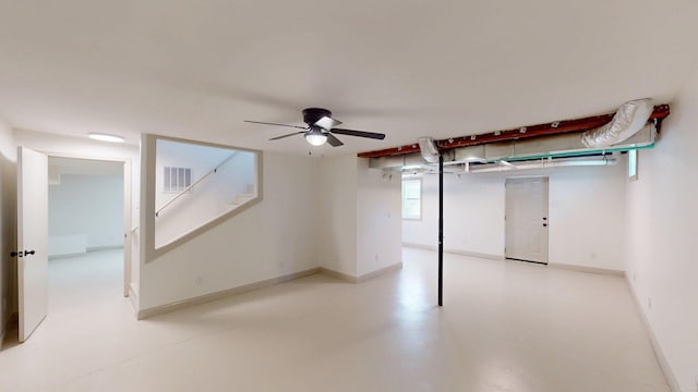 below grade area with a ceiling fan, baseboards, and visible vents