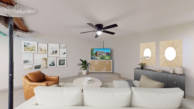 living room featuring ceiling fan and baseboards
