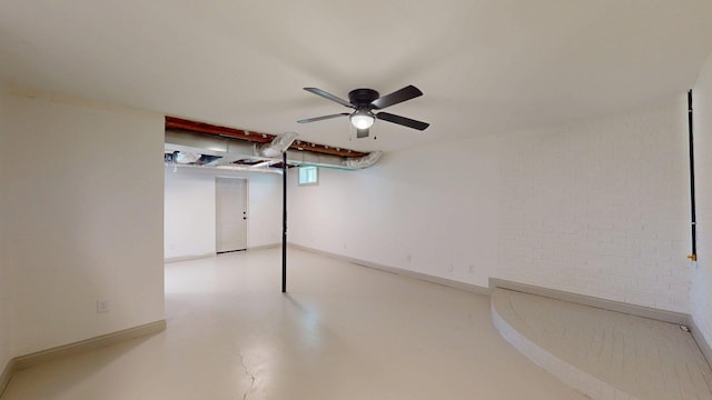 below grade area featuring baseboards and ceiling fan