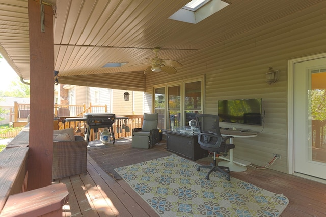 wooden terrace with a grill and ceiling fan