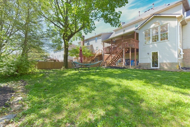 back of house with fence, stairway, a deck, and a yard