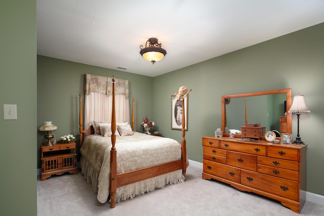 carpeted bedroom featuring baseboards and visible vents