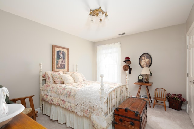bedroom with baseboards, light carpet, and visible vents