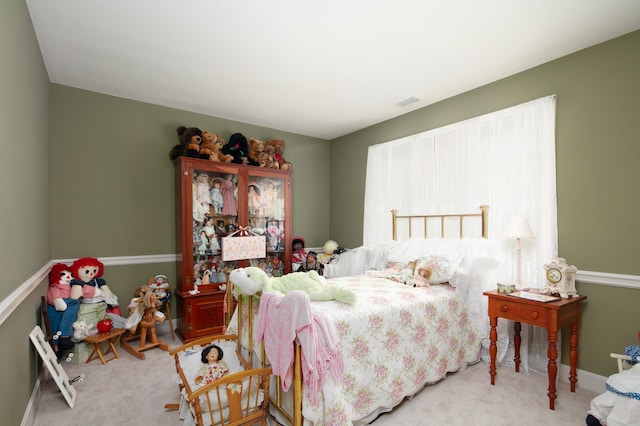 carpeted bedroom featuring baseboards and visible vents