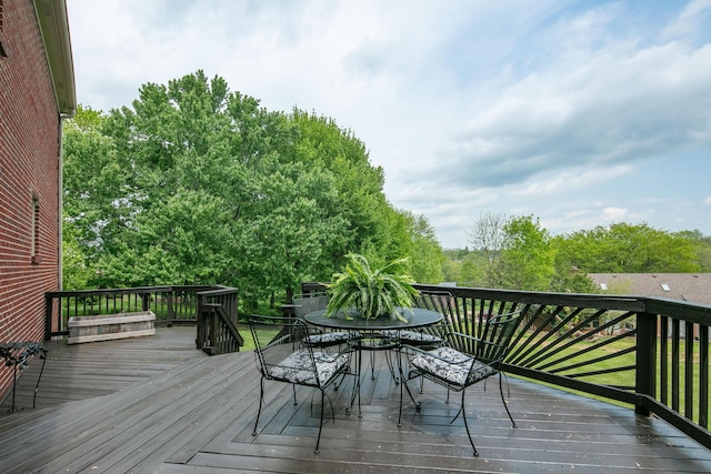 wooden terrace featuring outdoor dining space