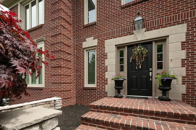 doorway to property with brick siding