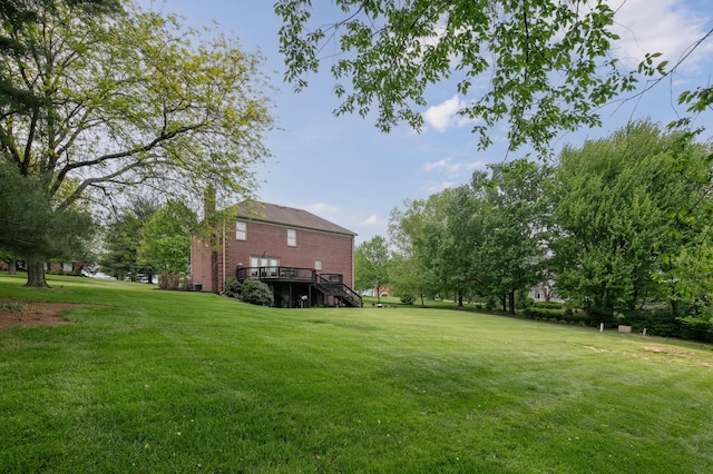 view of yard featuring a deck and stairs