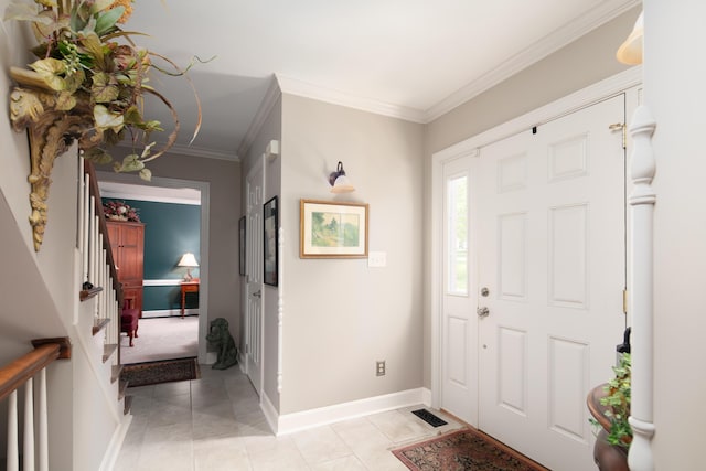 entrance foyer with visible vents, crown molding, baseboards, stairs, and light tile patterned flooring