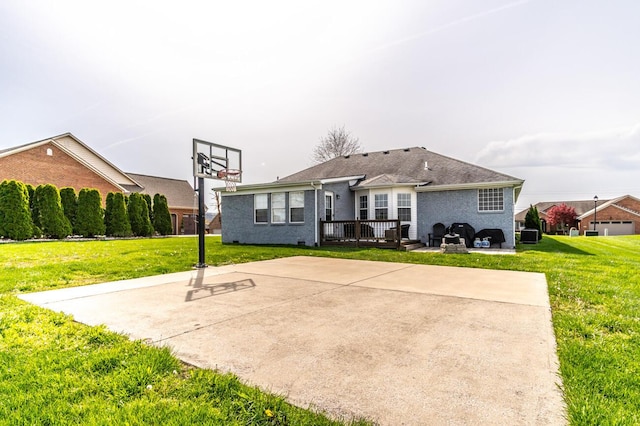 view of basketball court with basketball court and a yard