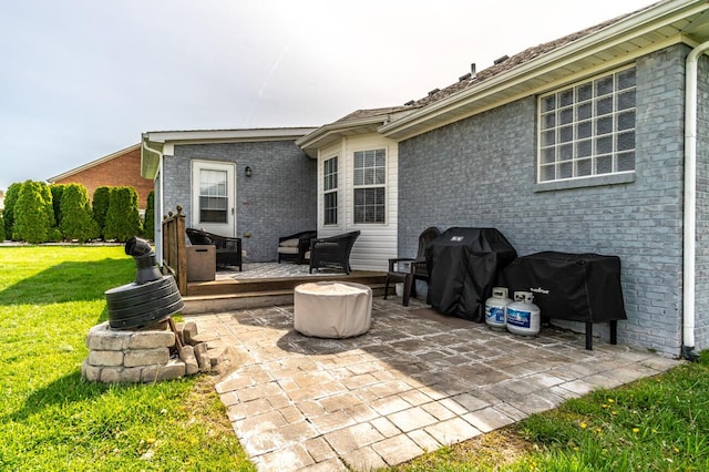 view of patio featuring a wooden deck and a grill