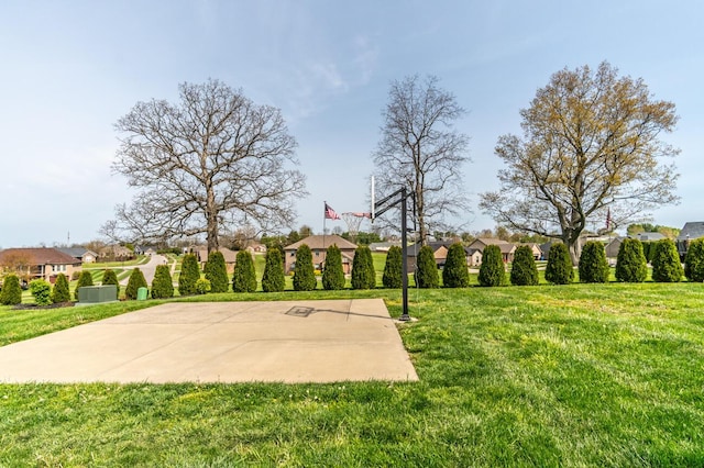 view of basketball court with a residential view, a yard, and community basketball court