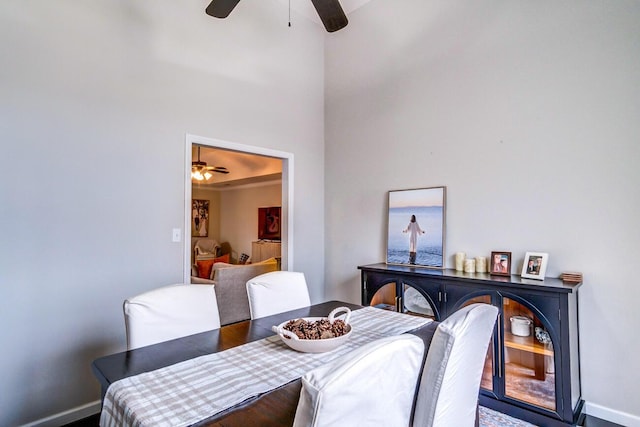 dining area with a ceiling fan and baseboards
