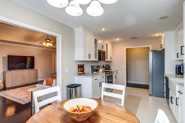 dining space with baseboards, visible vents, ceiling fan with notable chandelier, and recessed lighting